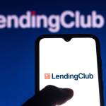 n this photo illustration the LendingClub logo is seen on a smartphone and a pc screen