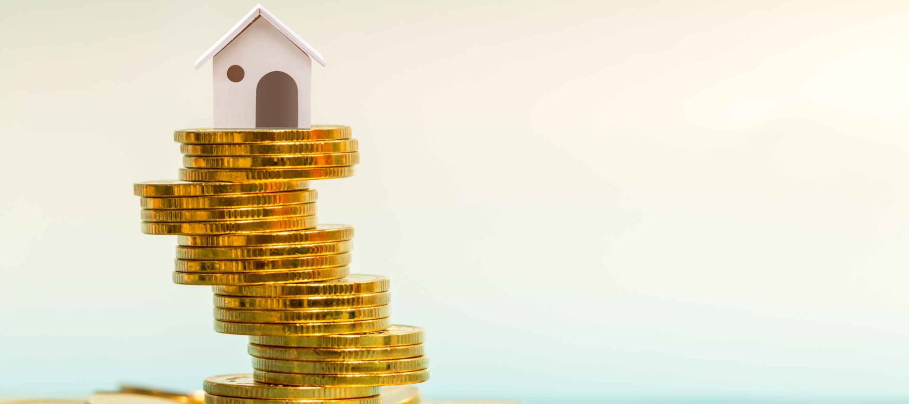 House stacked on tower of coins