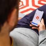 Man using the new Apple iPhone Xs with the immense OLED retina display and a12 bionic chip, looking over the app application Reddit news community app