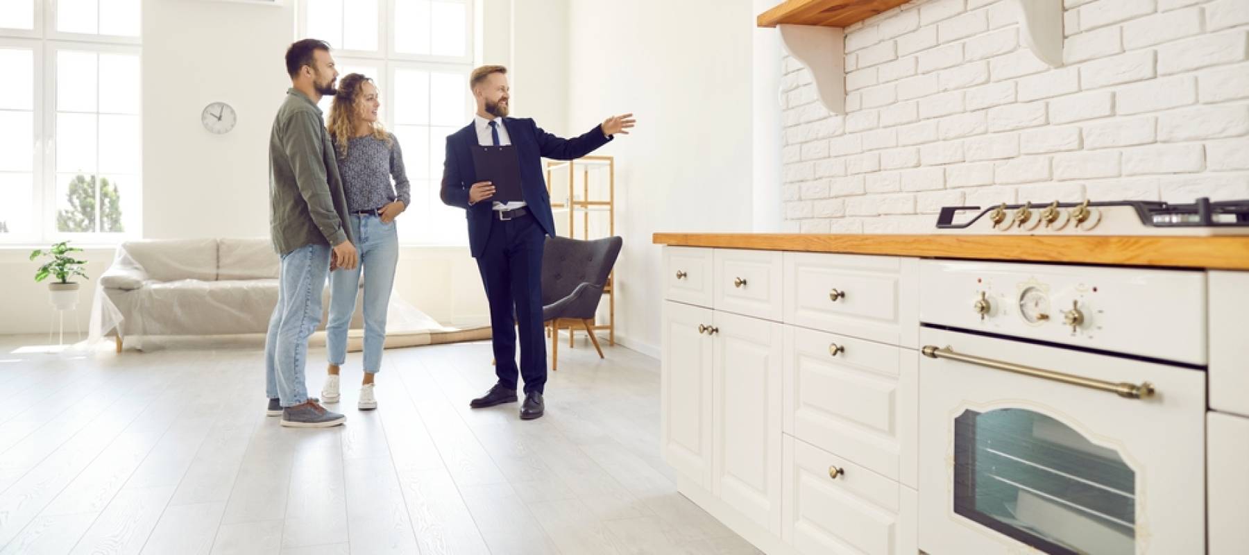 a couple looking at a rental property with a real estate agent