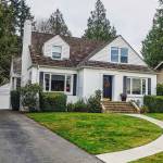 white colonial style suburban house with front walkway