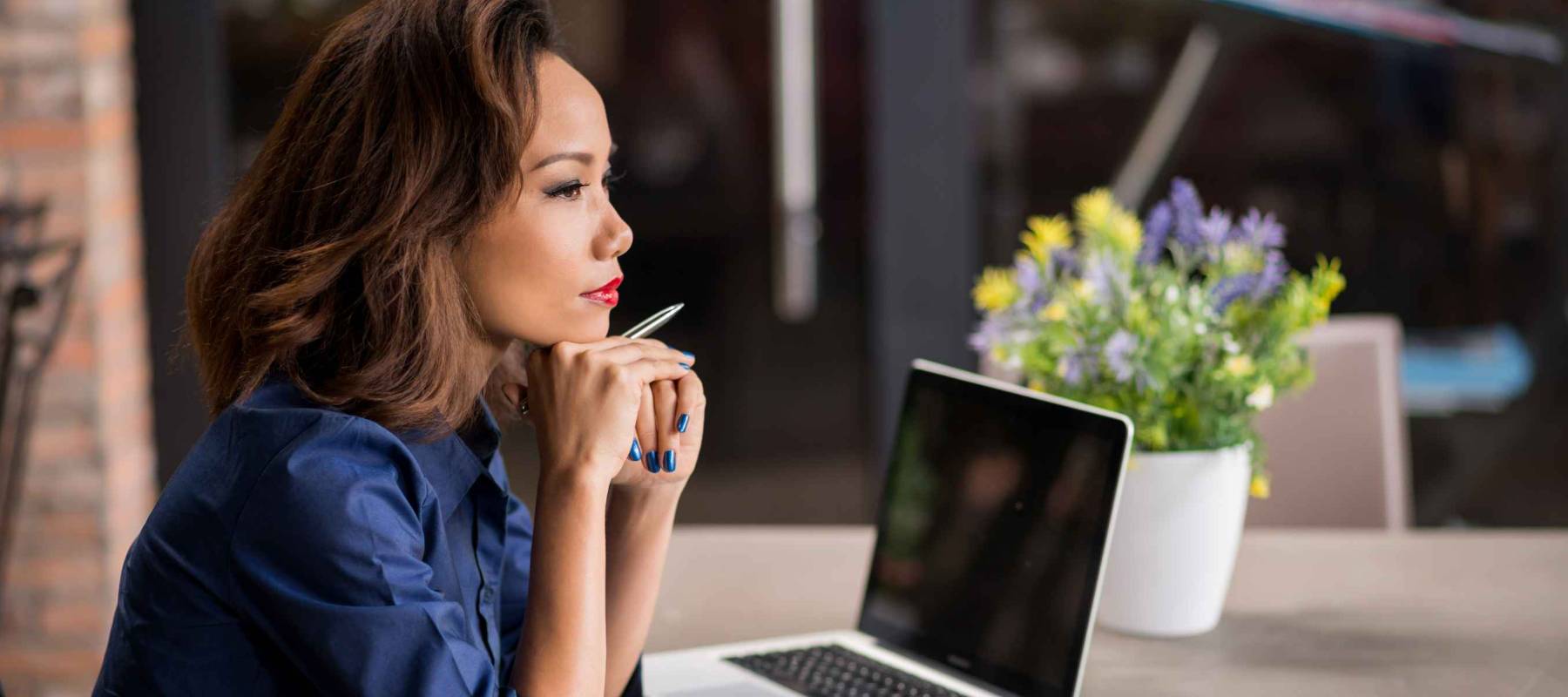 Vietnamese business lady pondering over ideas for new business project