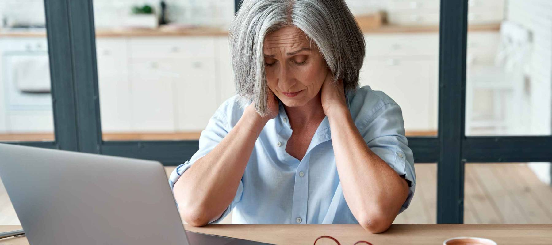 Tired stressed old mature business woman suffering from neck pain
