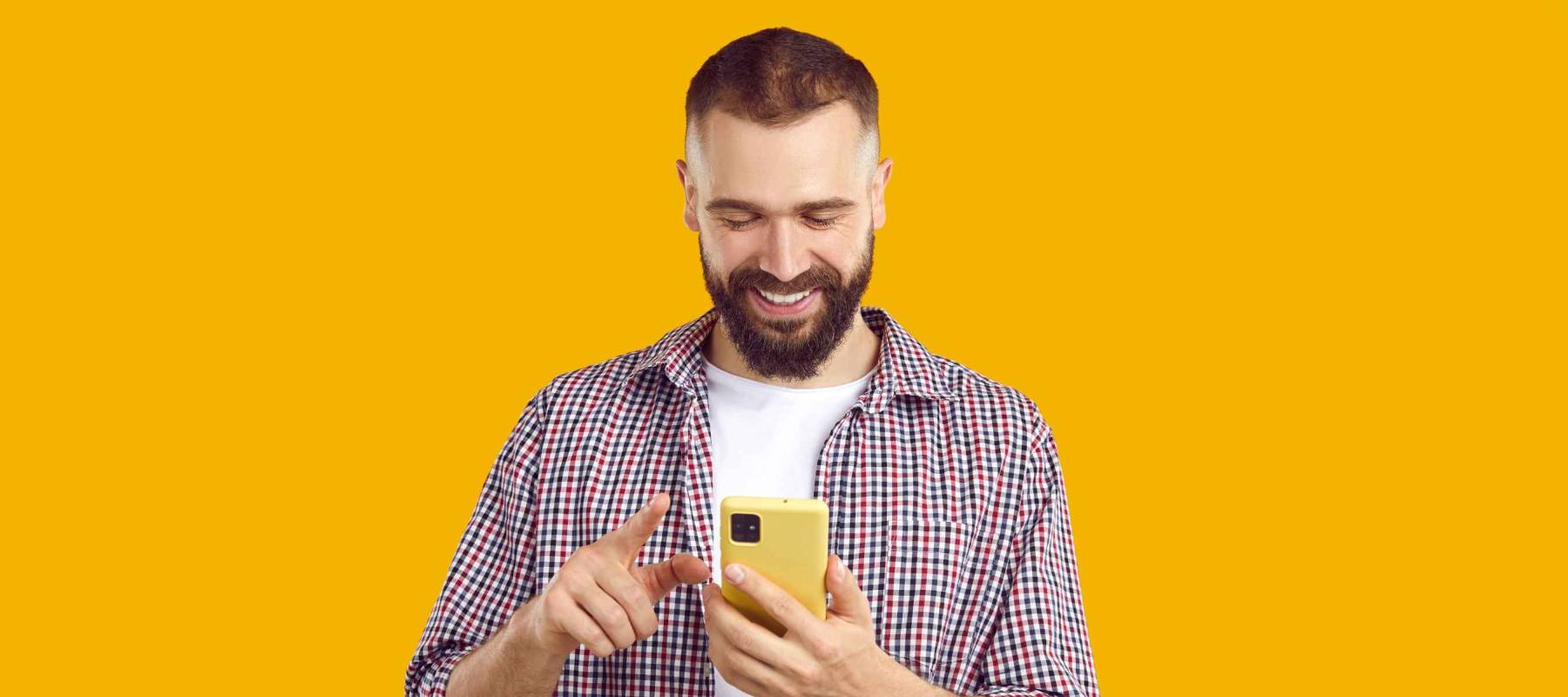 Man scrolls screen of mobile phone while browsing social networks