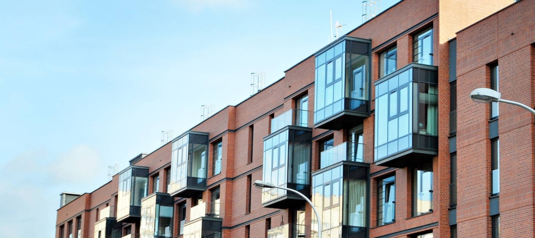 Modern apartment buildings on a sunny day with a blue sky. Facade of a modern apartment building