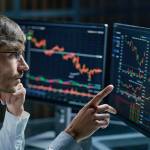 businessman comparing stock market data late in the evening .