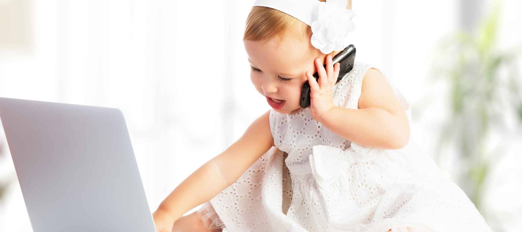 baby girl with computer laptop and mobile phone