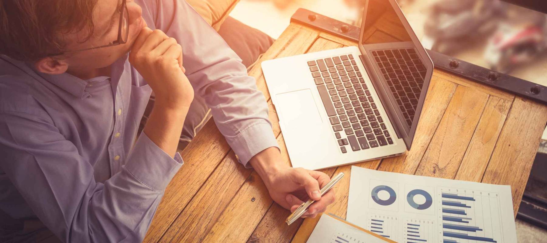 Businessman analyzing investment charts. Accounting