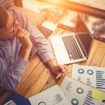 Businessman analyzing investment charts. Accounting