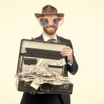 Get a million dollars. Rich man. Businessman hold suitcase with cash money. Win cash prize