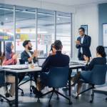 Multi-Ethnic Office Conference Room. Indian CEO does Presentation for Diverse Young Entrepreneurs,