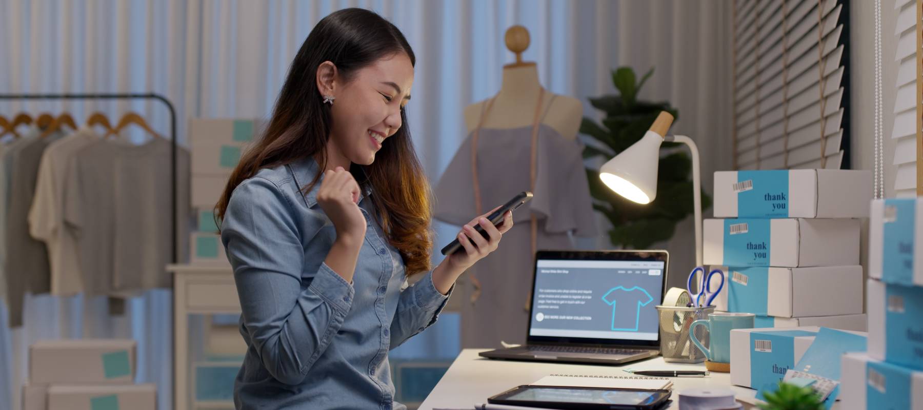 Young female entrepreneur smiling at her phone.