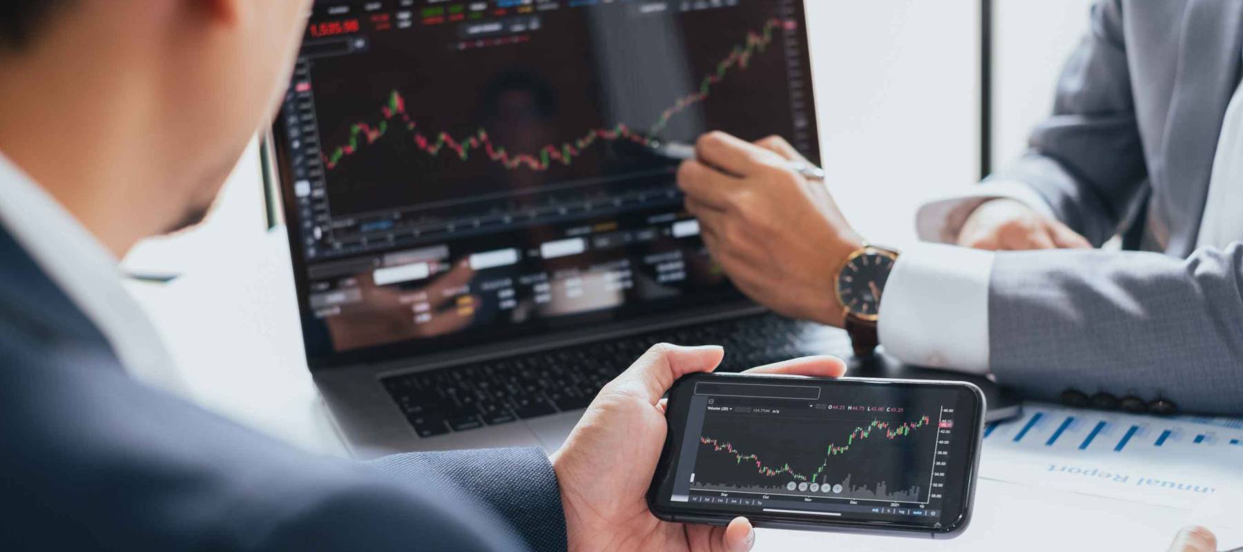 Businessman talking about investment stock market and graph from computer laptop with broker trader, giving money plan management and analysis