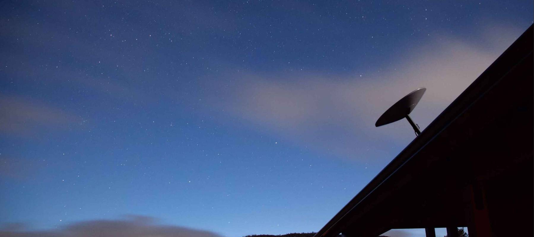 radar on house roof night sky