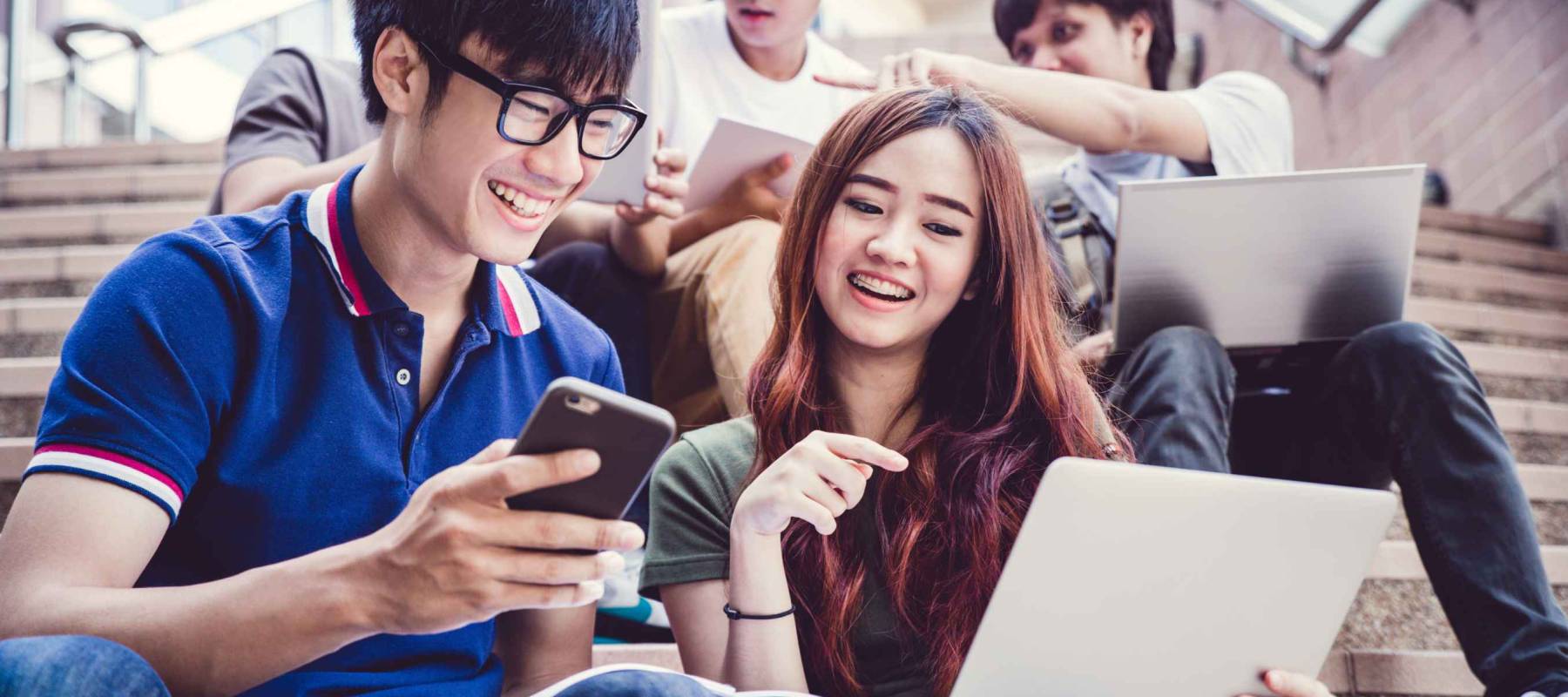 group of happy teen high school students outdoors