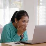 Asia people teen girl young worker workforce work at home office on table happy joy laugh smile with good news of job hired result on laptop