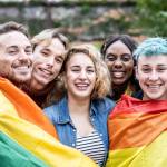 Group of young activist for lgbt rights with rainbow flag, diverse people of gay and lesbian community