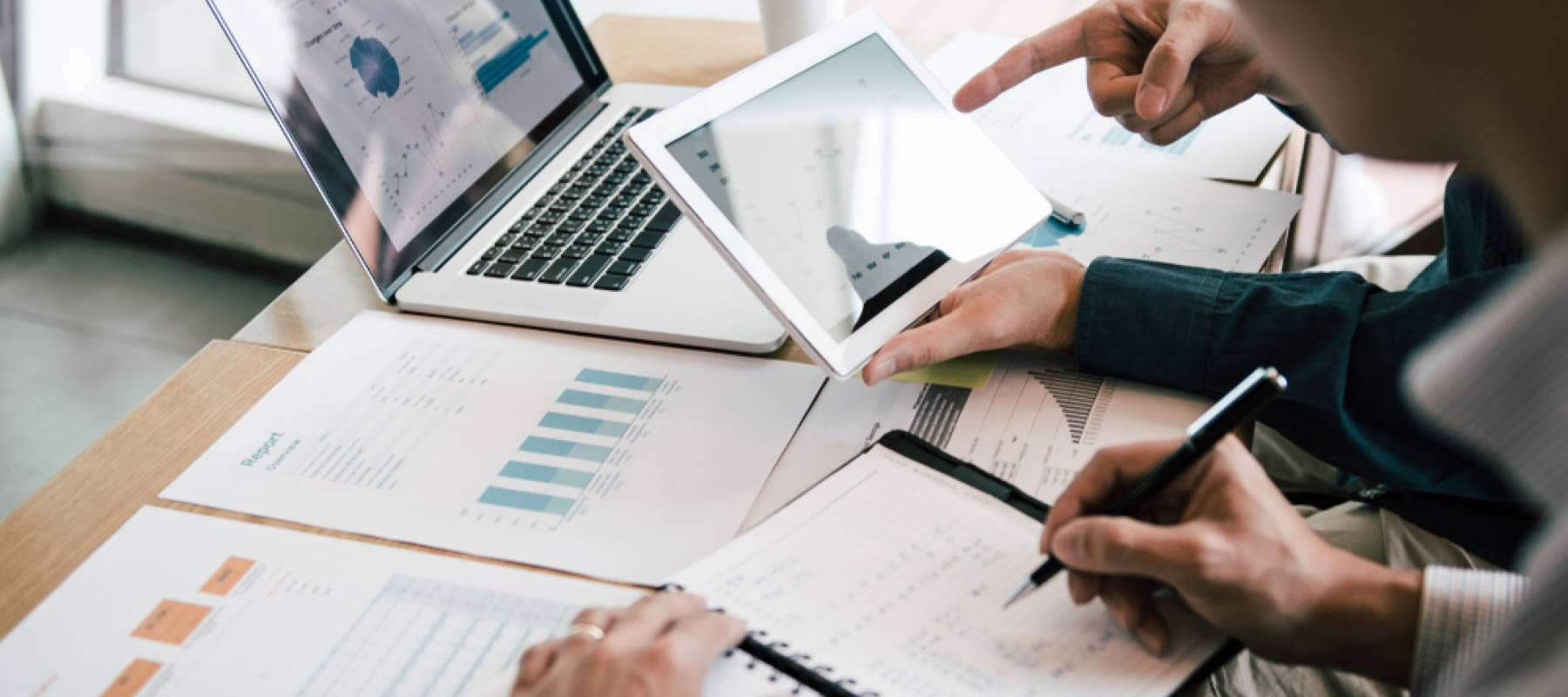 Business partnership coworkers using a tablet to analysis graph company financial budget report