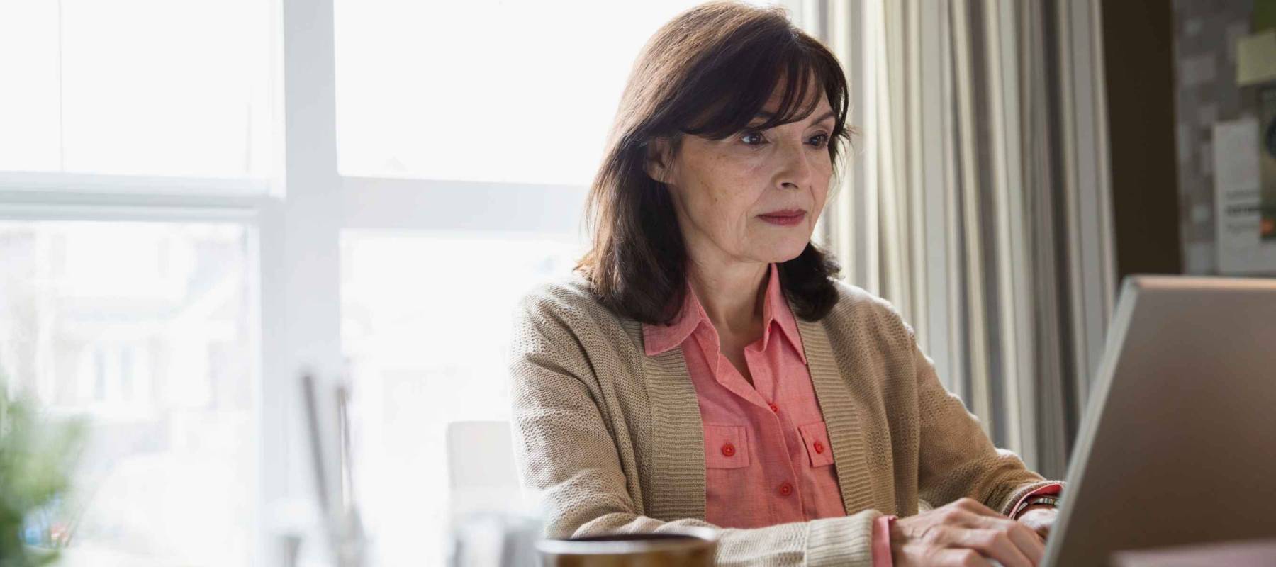 Woman using laptop in home office