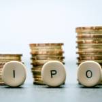 IPO letter blocks and stacked coins. IPO stands for Initial Public Offering.