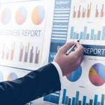 Businessman analyzing investment charts. Accounting