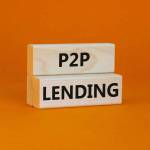 P2P peer to peer lending symbol. Concept words P2P lending on wooden blocks on a beautiful orange background. Business and P2P peer to peer lending concept. Copy space.