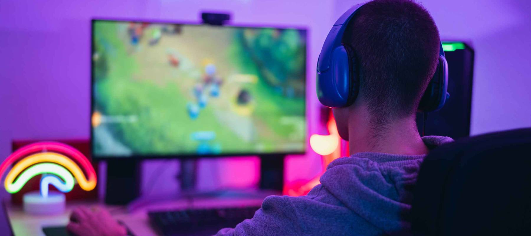 Young gamer playing online video games while streaming on social media - Youth people addicted to new technology game