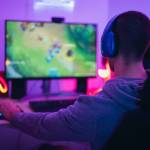 Young gamer playing online video games while streaming on social media - Youth people addicted to new technology game