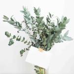 bouquet of flowers in vase with envelope clipped to it