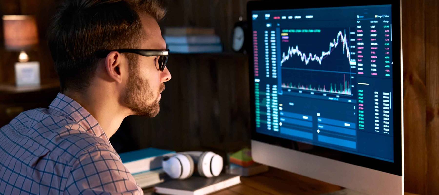 Serious business man trader analyst looking at computer monitor
