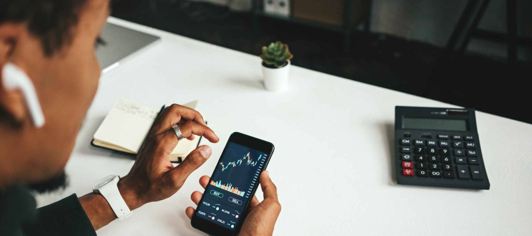 Mobile stock phone application. Young black man finance exchange and trading. Successful day