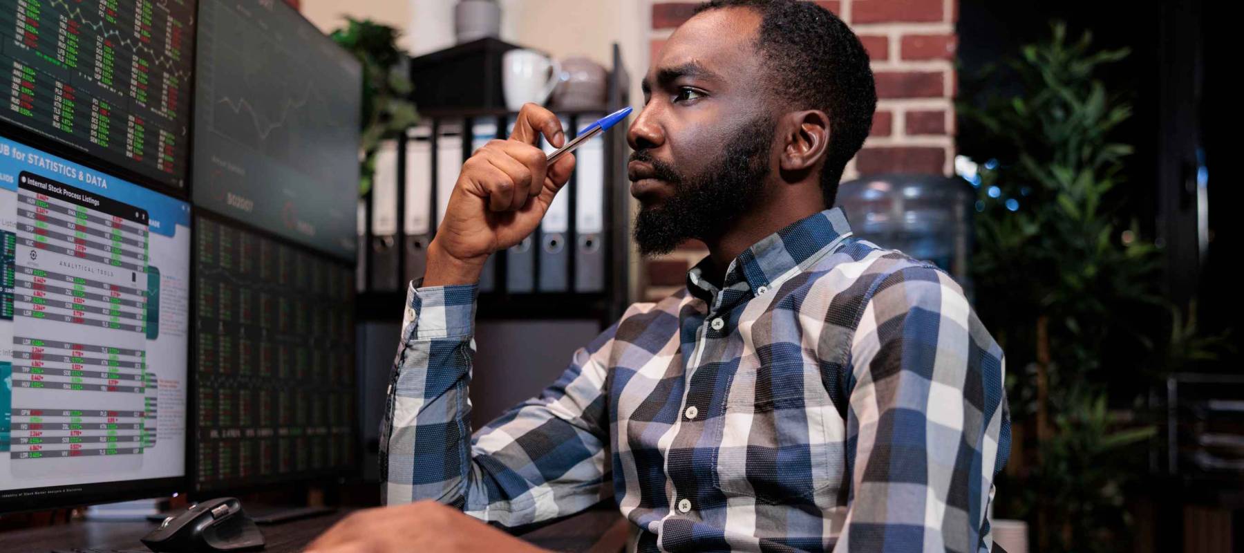 Brokerage company employee concentrated on forex stock market trend while following index marker. Investment agency data analyst thinking about risk free trading options.