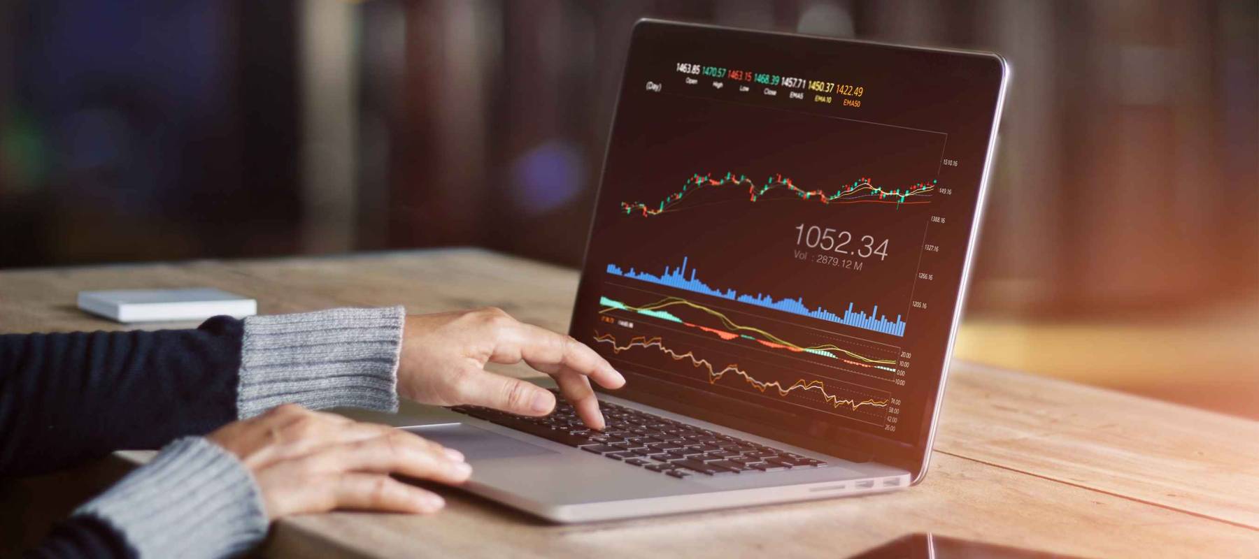 Businessman using laptop for analyzing data stock market, forex trading graph, stock exchange trading online, financial investment concept. All on laptop screen are designed up.