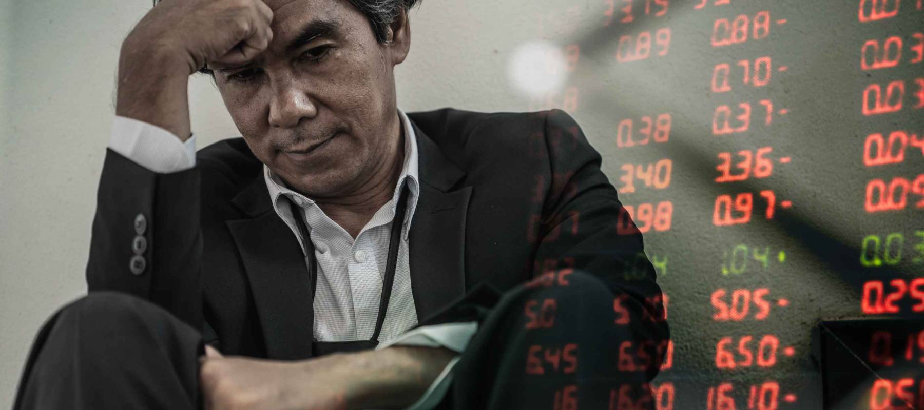 Businessman with chart in the fall. economy or stock market going down. Business man serious a falling down graph of stock market.