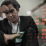 Businessman with chart in the fall. economy or stock market going down. Business man serious a falling down graph of stock market.