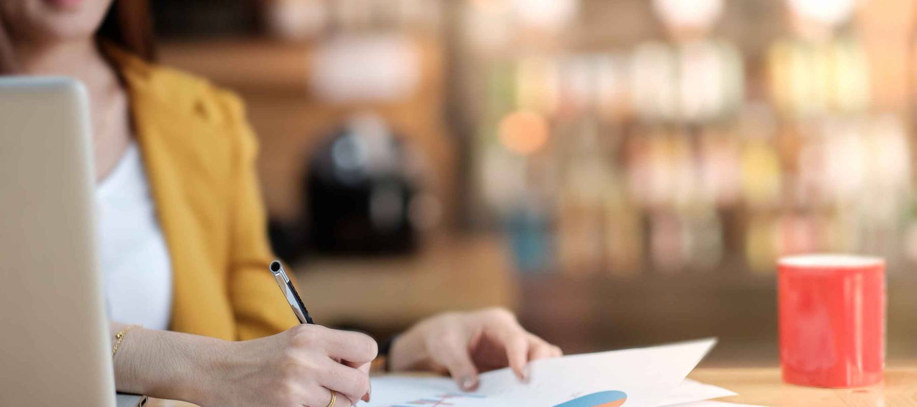 Asian business woman working with document and laptop in office.