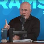 Dave Ramsey sits on the set of his show, talking into a microphone.