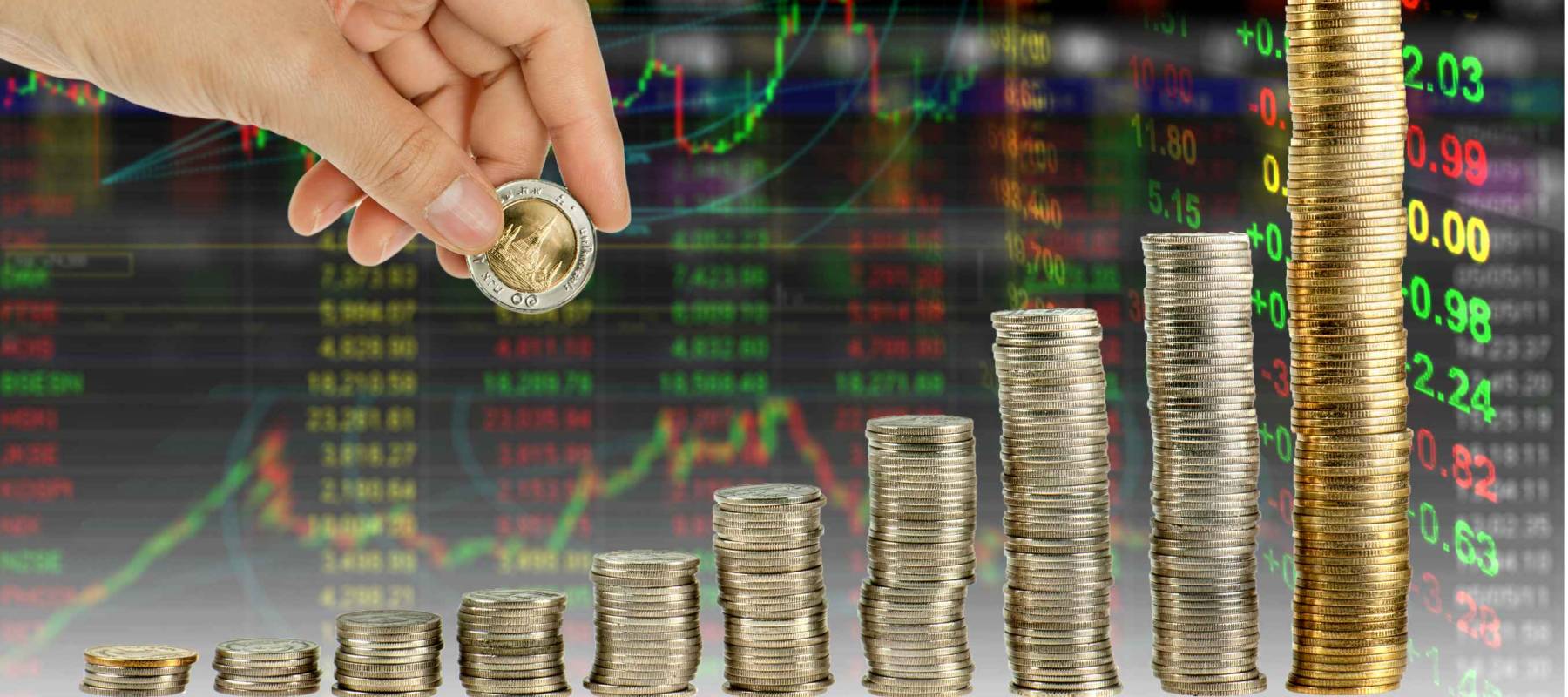 Hand make coin graph in stock index background. Financial education concept with hand putting many coins.  Tower of the coin is mean money or investment or saving, growth going up