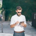 young businessman bearded outdoor using tablet - remote working, technology, communication concept