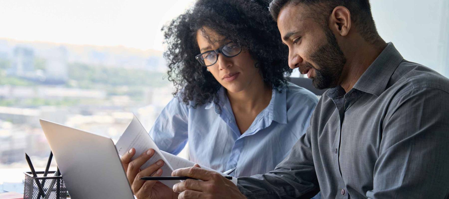 Multiethnic male indian mentor and female African American intern