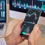 Crypto trader investor broker using smartphone app analyzing financial data