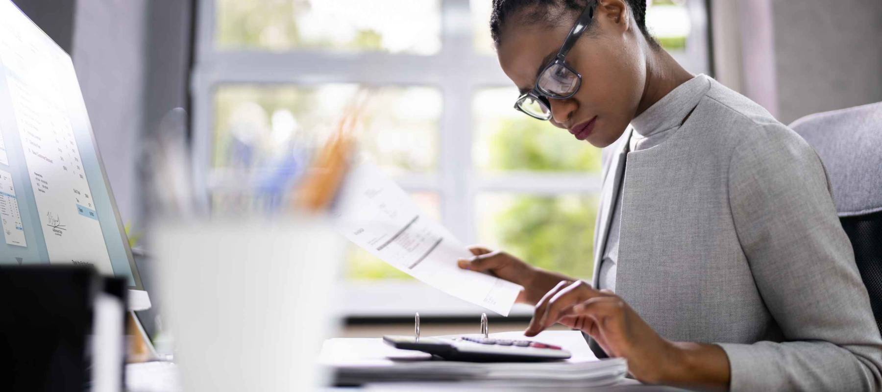 African American Accountant Or Auditor With Calculator