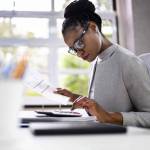 African American Accountant Or Auditor With Calculator