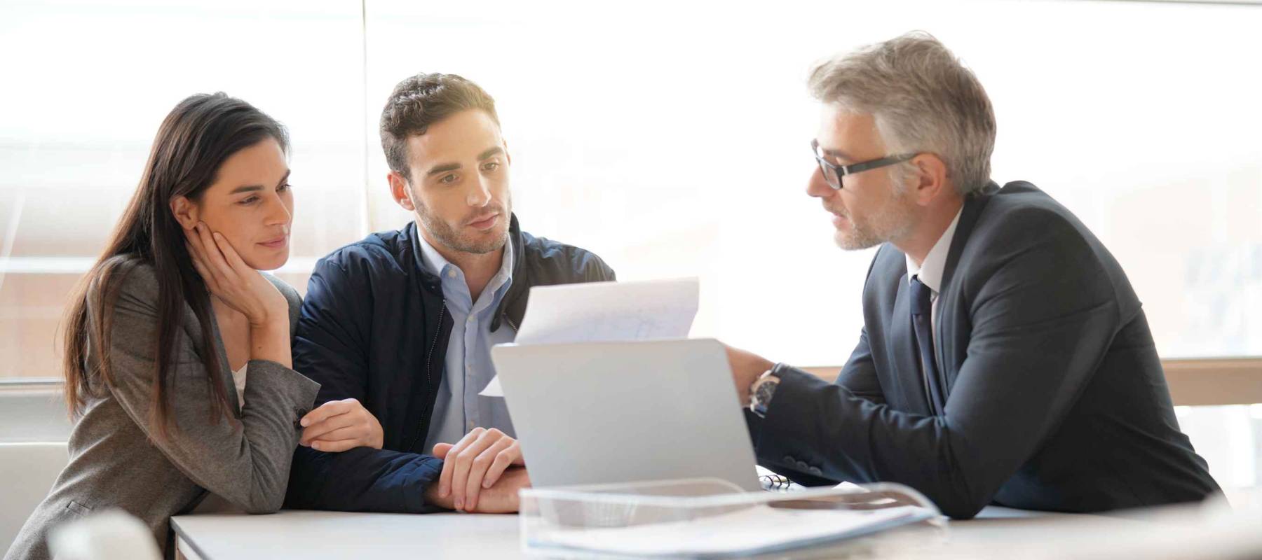 Young couple meeting financial advisor for home investment