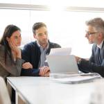Young couple meeting financial advisor for home investment