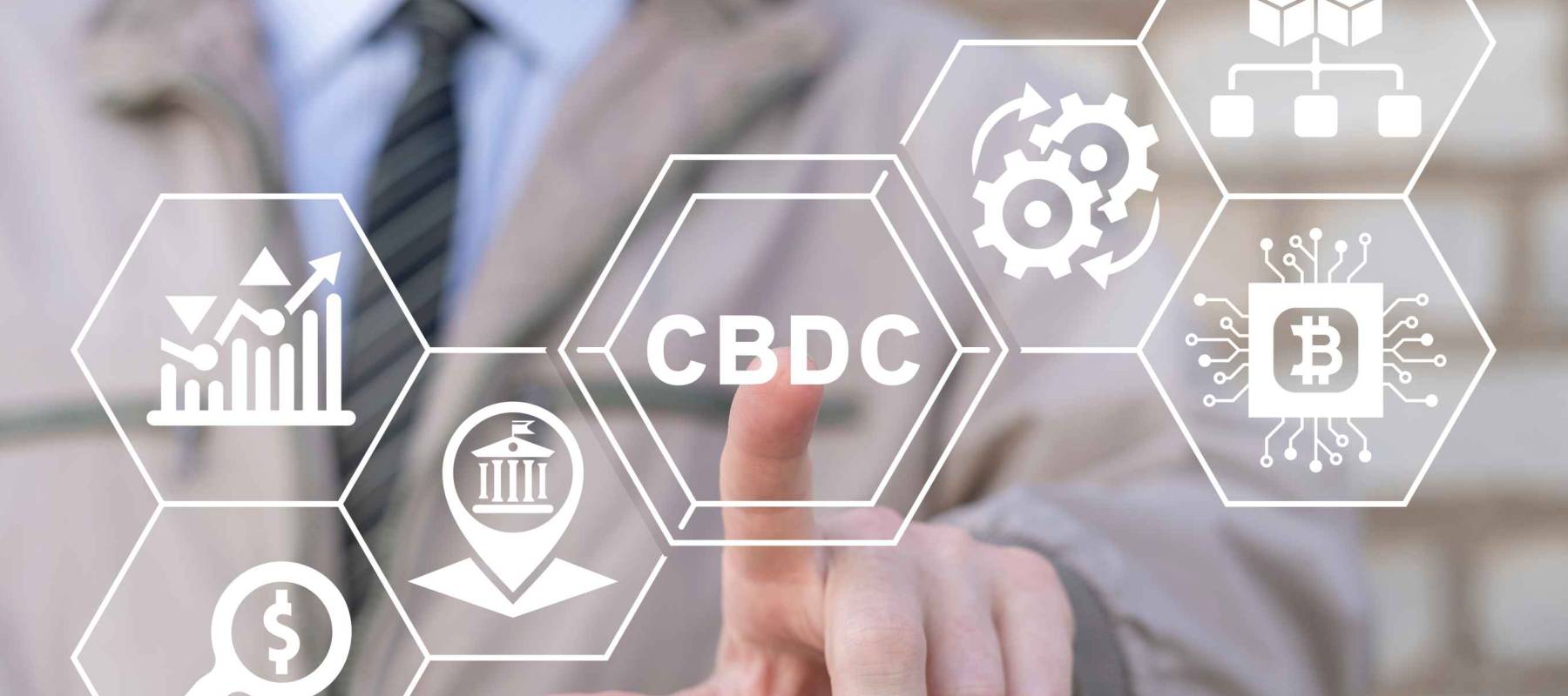 Businessman using virtual touchscreen presses abbreviation: CBDC.