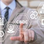 Businessman using virtual touchscreen presses abbreviation: CBDC.