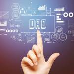 DAO- Decentralized Autonomous Organization theme with hand pressing a button on a technology screen