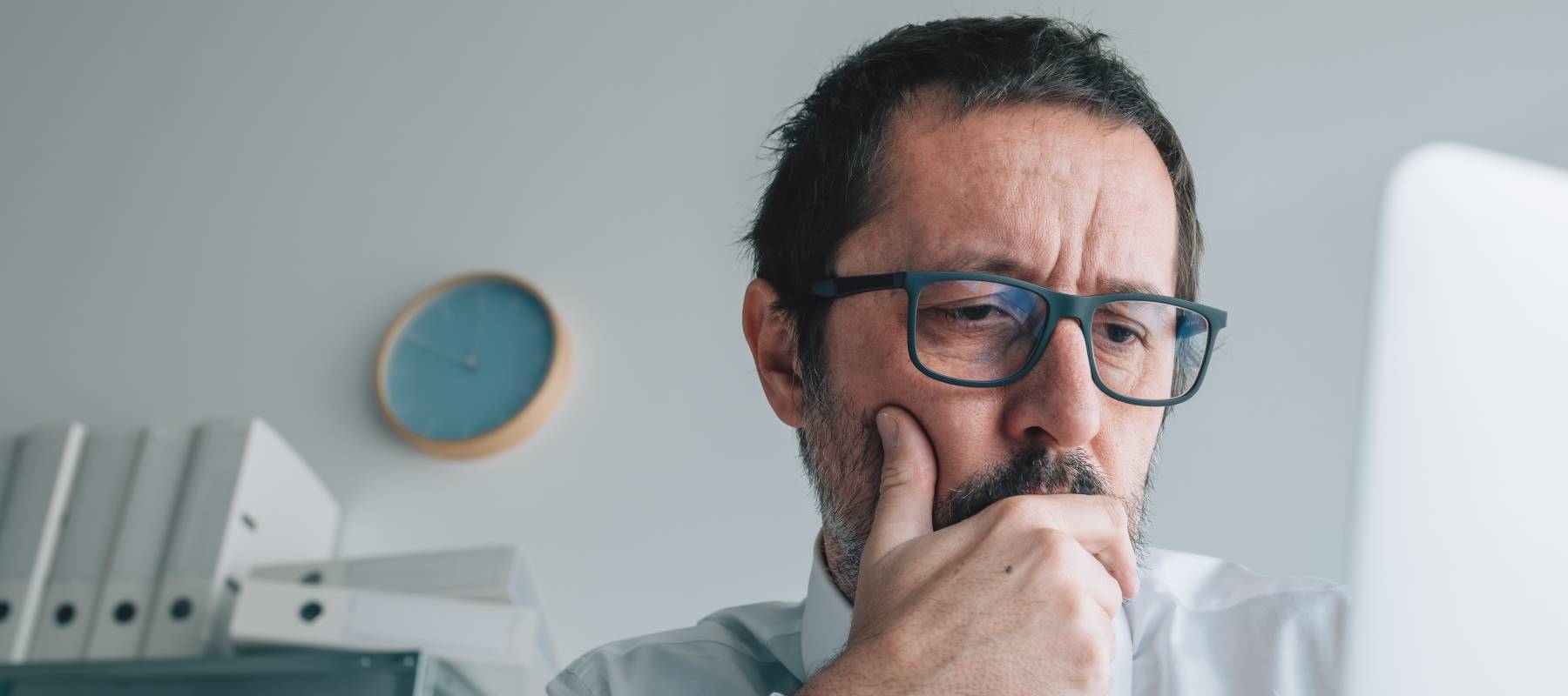Worried shareholder analyzing stock prices on online market from business office, selective focus