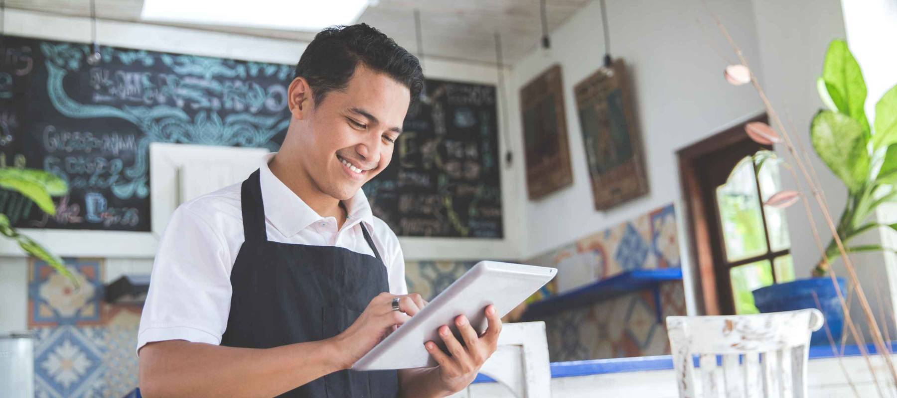 portrait of asian young male cafe owner with tablet
